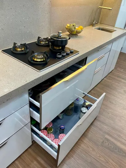 A parallel kitchen design with organized tandem drawers for efficient storage.