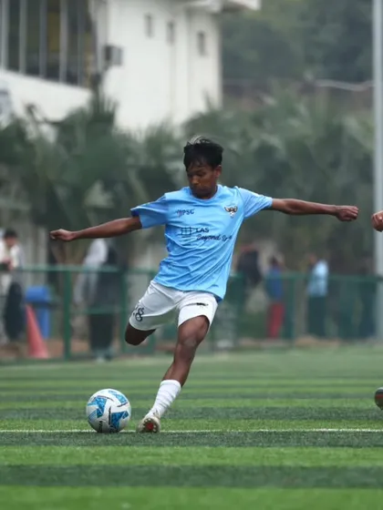 Caught in the moment, fueled by adrenaline. A player takes a powerful shot during a match, demonstrating the attacking football we encourage.