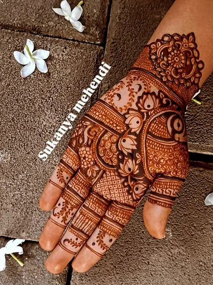 A classic, intricate design perfect for Karvachauth or any festive occasion, filled with lotuses, peacocks, and detailed line work.