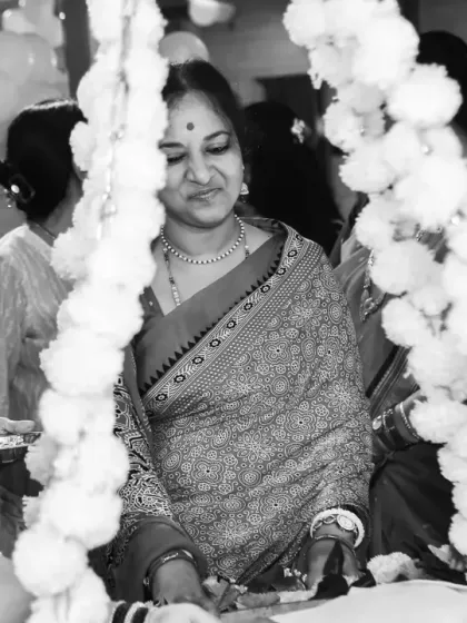 A beautiful black and white scene from a naming ceremony. This candid shot captures multiple generations of women participating in the ritual, telling a story of family, tradition, and community.