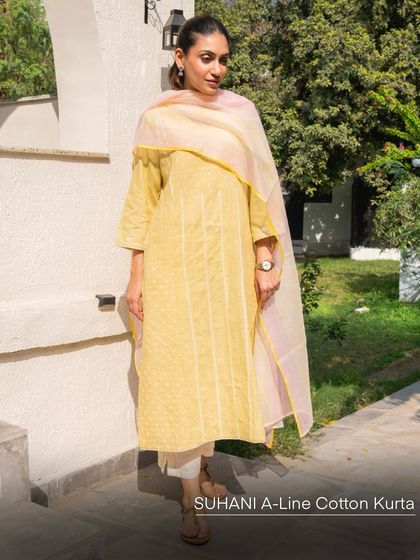 The Suhani A-Line Cotton Kurta in yellow Bandhani, styled with a light Kota dupatta. The combination of hand-tied patterns and delicate embroidery creates a look that is both traditional and effortlessly chic.