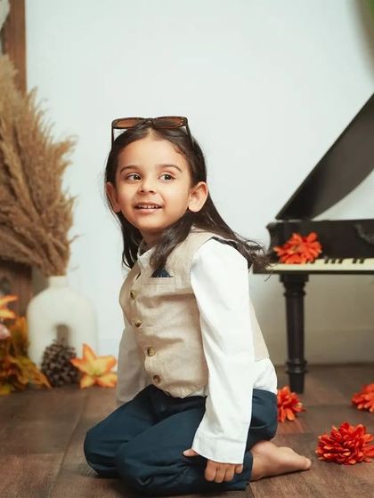 A thoughtful portrait of a boy before his mundan ceremony. This is a special milestone to capture before their first haircut.