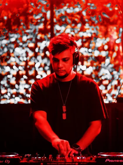 A portrait of me at the decks, bathed in red light. The color and focused expression reflect the intensity I bring to my melodic techno and house sets.