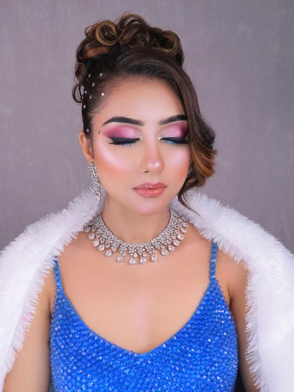 A stunning party look with a creative pink and blue eye, messy bun, and diamond jewelry. This shows the versatility of looks you can learn to create.