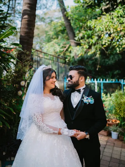 A stylish portrait of the bride and groom, with the groom wearing sunglasses for a cool, modern touch to their Christian wedding photos.