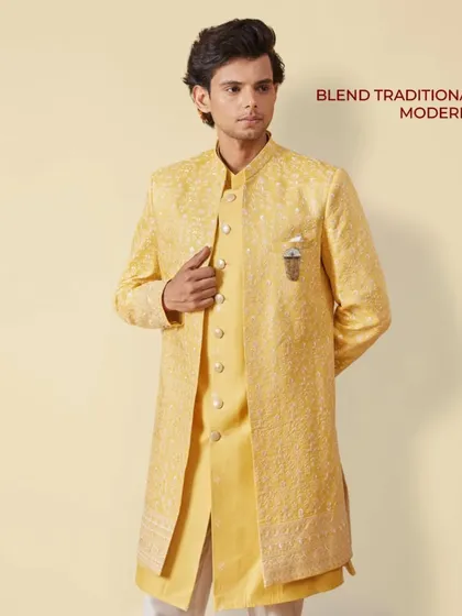 East meets West in this layered yellow Indo-Western outfit. The embroidered jacket over a matching kurta is a perfect way to blend traditional with modern style.
