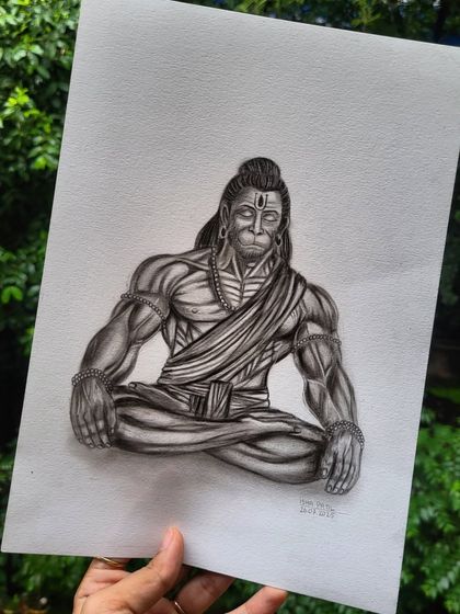 My Hanuman sketch held against a natural backdrop. This view highlights the contrast between the detailed, powerful artwork and the calm of nature, reflecting the balance of strength and peace he represents.