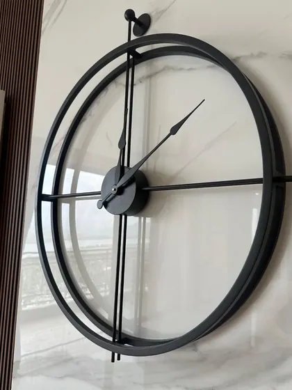 This angle shows the slim profile and clean construction of our minimalist double-ring wall clock. The antique black finish gives it a subtle, sophisticated texture that looks great against a marble or textured wall.