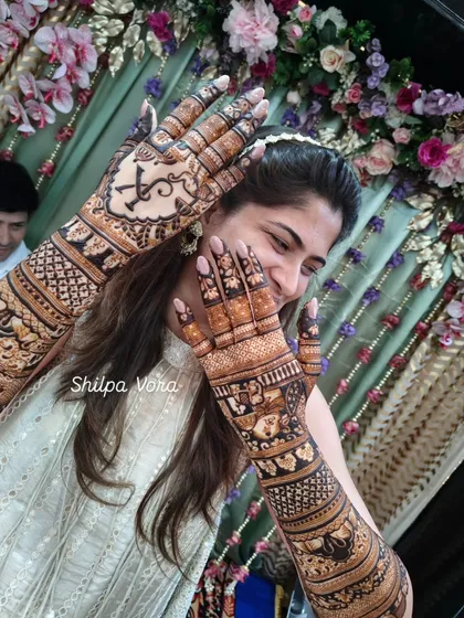 Another playful shot of the bride and her intricate story mehndi. The design is filled with details that are personal to her.