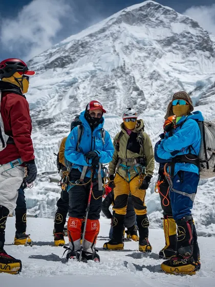 A team briefing at Everest Base Camp. Before we take on the giants, we come together as a tribe. Here, our experienced leaders and Sherpa guides discuss strategy, safety, and the path ahead. Preparation and teamwork are the bedrock of every successful expedition.