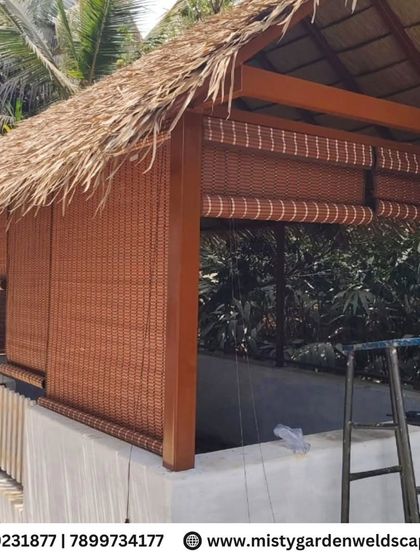 The cow shed with bamboo roller blinds installed. This addition provides extra protection from sun and rain while allowing for adjustable airflow, enhancing the comfort of the animals inside.