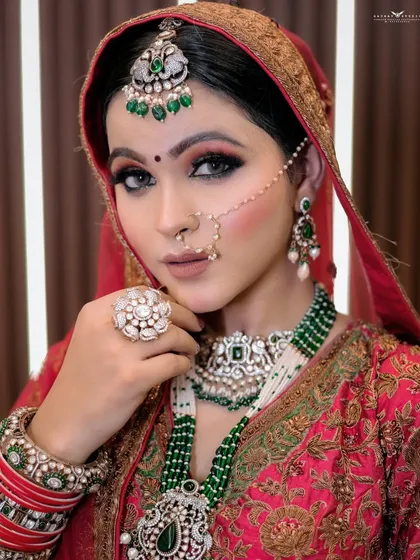 A close-up focusing on the large, ornate ring and the details of the bridal necklace.