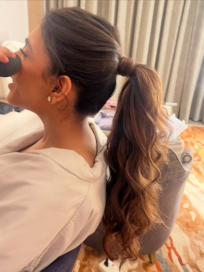A behind the scenes look at creating a voluminous ponytail on highlighted hair.