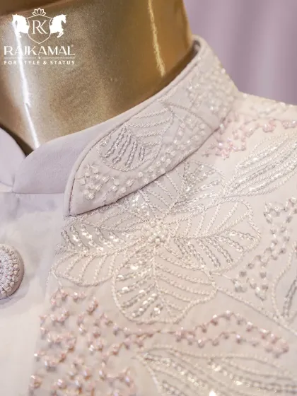 A close-up of the collar of the white Indo-Western jacket, highlighting the detailed beadwork and sequins.