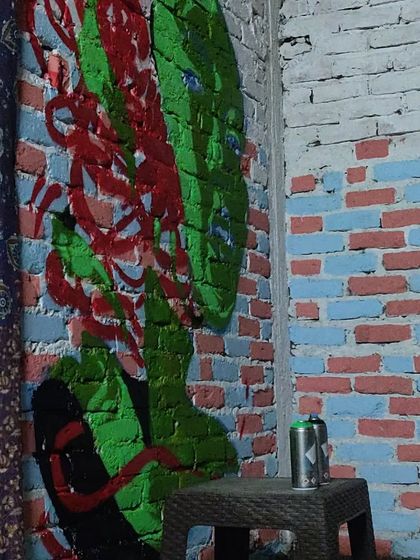Another shot of the "Queen of Hearts" themed mural in Pulga. The exposed brick wall adds a great texture to the artwork, blending raw street style with an indoor setting.