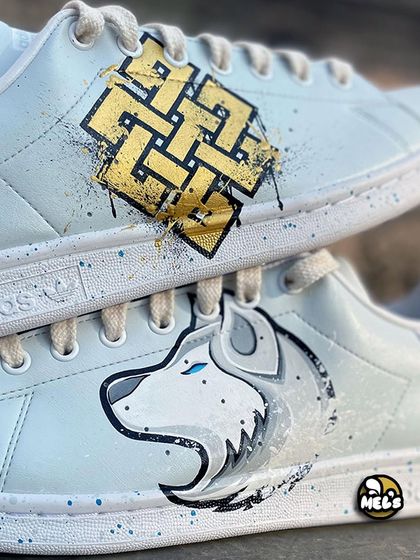 A detailed close-up of the Karma symbol and white wolf designs, showing the intricate lines and paint splatters.