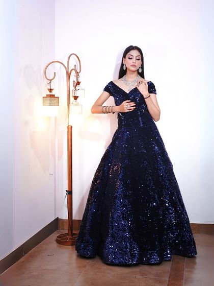 A full-length view of the navy sequin gown, a perfect choice for a glamorous evening look.