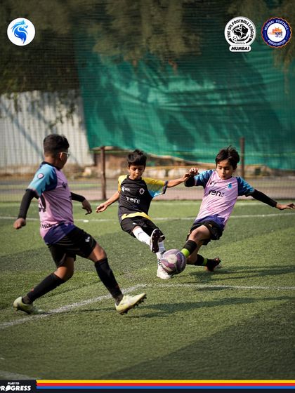 Three players, one ball. This photo captures the heart of the midfield battle during an intense SFL Mumbai match.