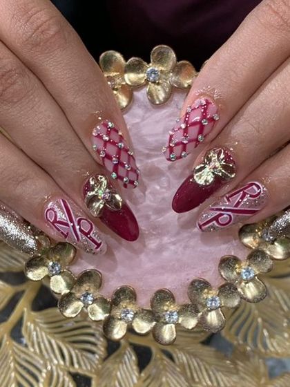 Custom initial nail art for a bride, featuring the couple's initials, quilted patterns, and 3D gold bow embellishments.