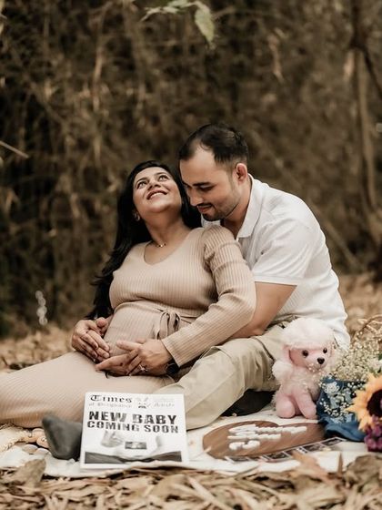 A beautiful picnic scene in the woods. The couple is relaxed and happy, surrounded by props that tell their story.