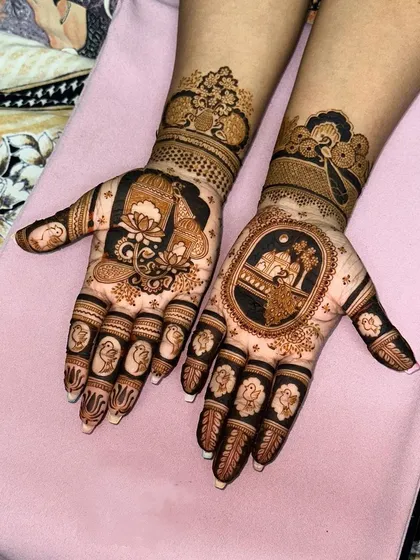 A unique design with a central focus on a 'jharokha' scene on one hand, and a large lotus motif on the other, both tied together with similar wrist patterns.