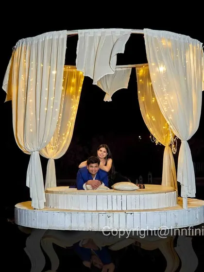 A dramatic night shot at our floating gazebo, with the dark background making the illuminated set and the couple truly stand out.