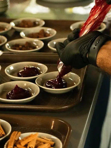 A chef carefully plating one of the tasting elements for our chocolate workshop. Every detail is considered to provide a complete sensory journey, from the raw ingredients to the final presentation.