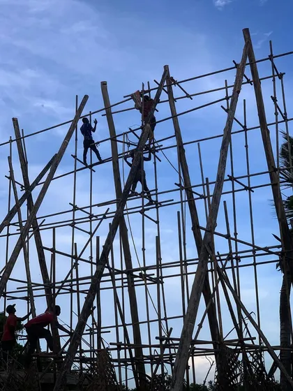 A silhouette of the spa's scaffolding and the workers climbing it at dusk. This image captures the energy and activity of the construction site as the building begins to take shape.
