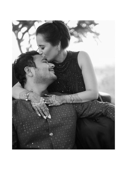 A tender moment during Sushant and Akanksha's pre-wedding events. The gentle forehead kiss, captured in classic black and white, is a timeless expression of love and intimacy.