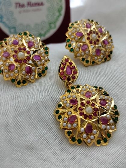 A beautiful Jadau pendant set with a floral motif in ruby and emerald colours. This is a classic design that never goes out of style.