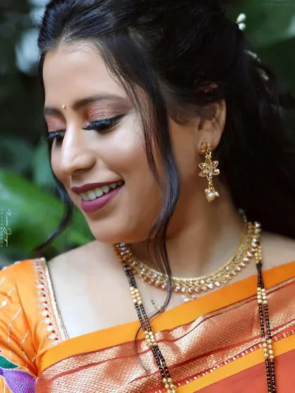 A close-up of a subtle bridal look. The focus is on glowing skin and soft, romantic eye makeup that enhances her natural beauty.