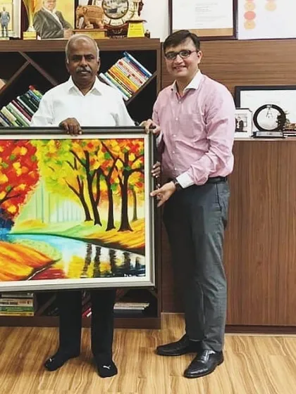Dr. Arokiaswamy Velumani with the custom autumn landscape I created for him. This piece was made entirely with a palette knife to achieve its rich, warm colors and textures.