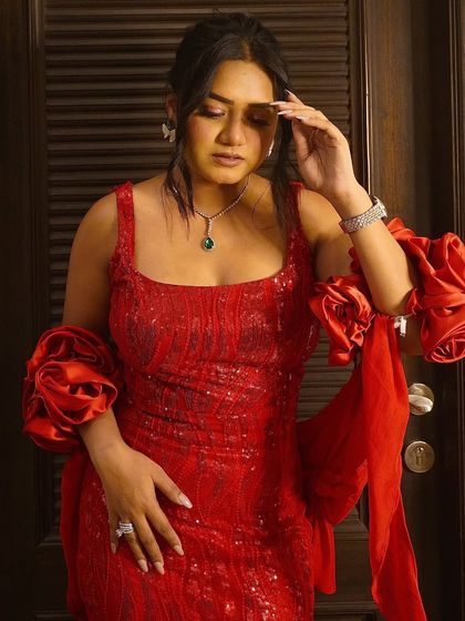 Feeling powerful in this stunning red sequin gown with dramatic ruffled sleeves. Red is the color of celebration, and this dress is perfect for making a statement.