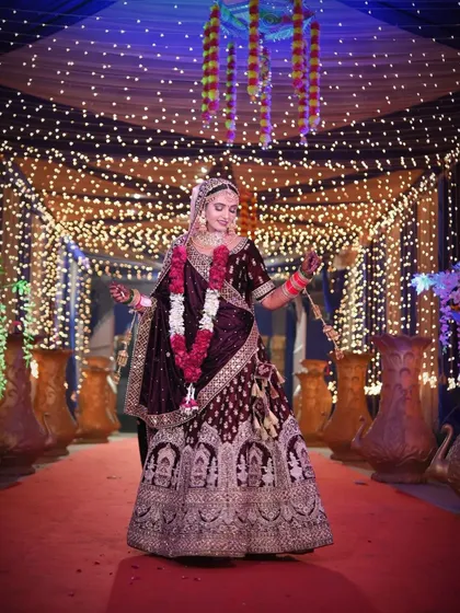 A full-length bridal portrait showcasing her magnificent lehenga as she twirls under a canopy of fairy lights.