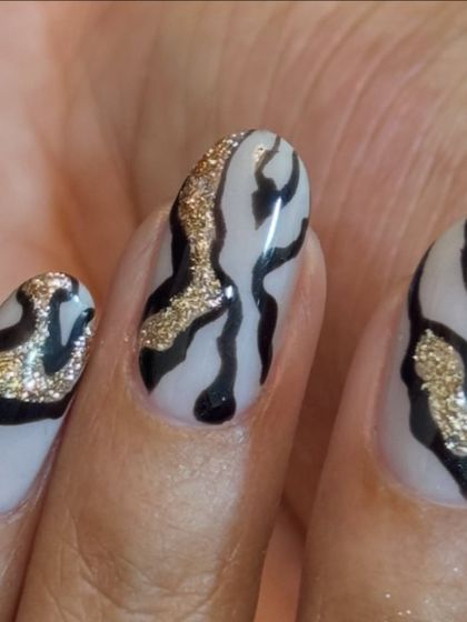 A close-up of the glittery zebra stripe nail art. The detail is everything.