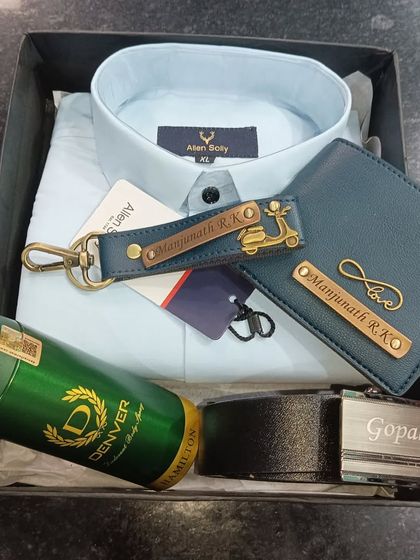 A complete personalized gift hamper with an Allen Solly shirt, a custom name belt, a personalized wallet and keychain, and a deodorant.