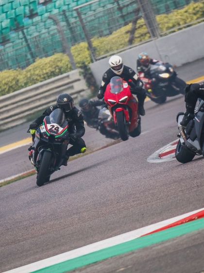 Four riders on various superbikes are captured mid corner, showcasing a dynamic moment of high speed action during an Apex track day at the BIC.