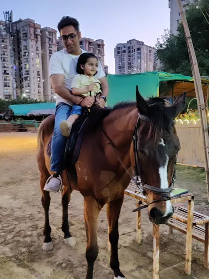 We love creating unforgettable family moments. Here, a father enjoys a safe and gentle ride with his young daughter, showing that horse riding can be a joy for all ages.