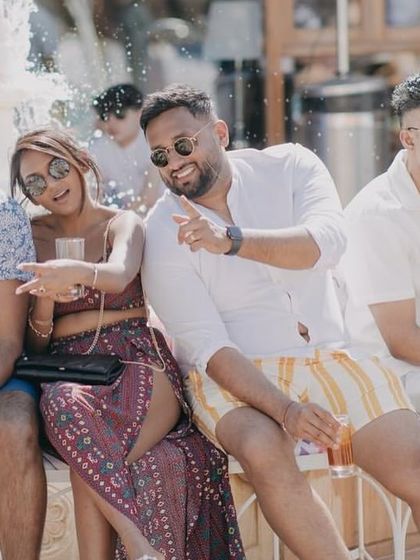 Guests enjoying the sun and cocktails by the pool, a perfect way to unwind after the wedding festivities.