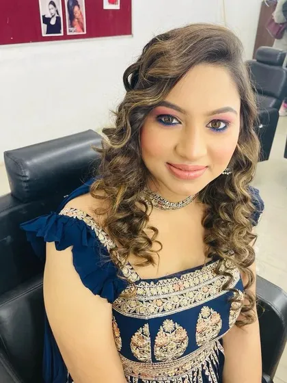This is a great example of party makeup for a wedding guest. I created a vibrant pink and blue smokey eye that pops, paired with a glossy nude lip and soft curls to complete the festive look.