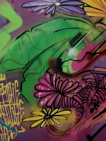 A close-up on a hummingbird and leaf detail from the nature-themed mural.