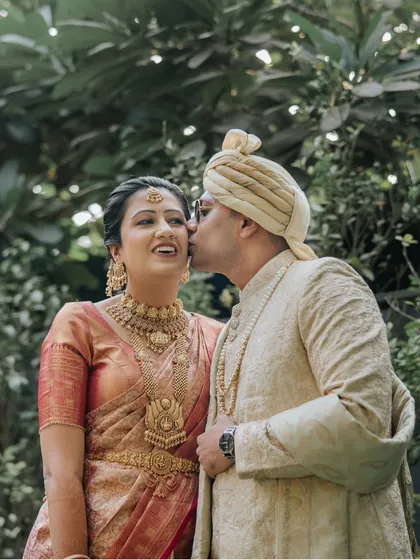A sweet kiss on the cheek. This candid moment between the South Indian bride and her Punjabi groom perfectly encapsulates the love and joy of their fusion wedding.