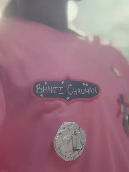 A detail shot of the DIY name tag and medals on the child's uniform. These small, handcrafted elements were essential for showing her creativity and the personal start of her dream to join the army.