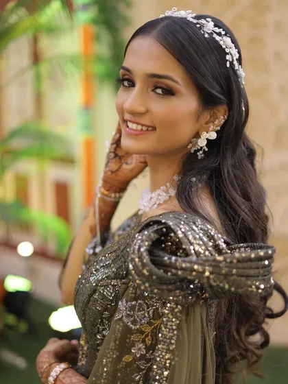A close-up of this stunning look, highlighting the intricate hair accessory and the flawless makeup.