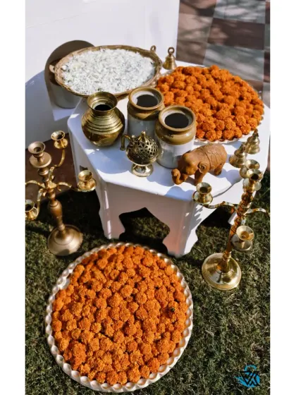 The small details matter. For this Haldi, we arranged traditional elements like brass pots, marigold platters, and rice in an artistic display.