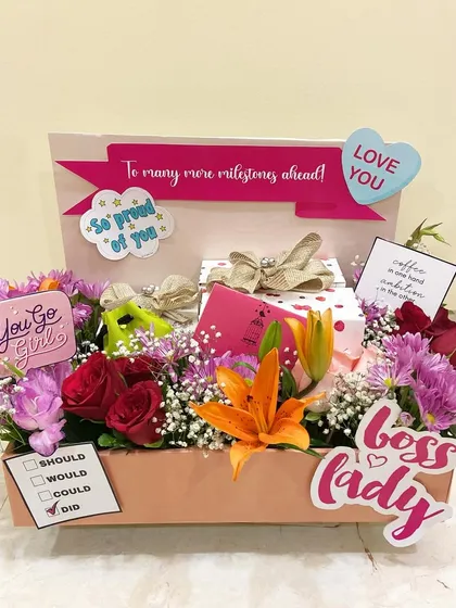 A 'Boss Lady' themed hamper to celebrate a milestone, perfect for a mother who inspires you. It's filled with flowers and motivational goodies.