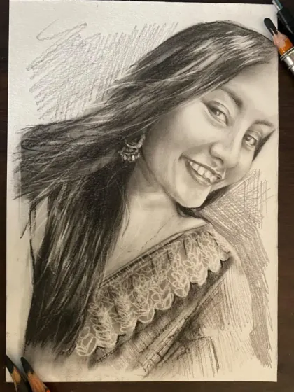 A lively charcoal sketch capturing a woman's joyful expression and the intricate details of her saree.