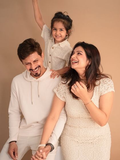 Laughter and love in the studio. This candid moment captures the fun and playful side of this family, showing that studio portraits can be full of life and personality.