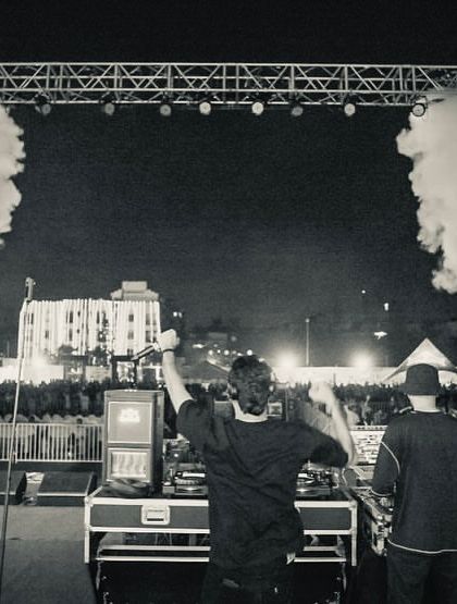 A black and white shot from behind the decks at my show in Patna, capturing the scale of the stage and crowd.