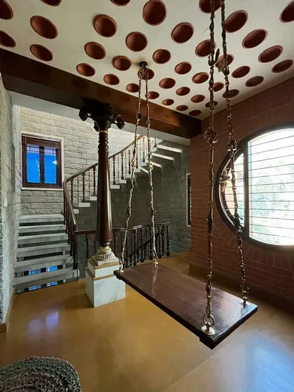 A view of the indoor swing, showing its relationship to the stone-clad spiral staircase in the background.